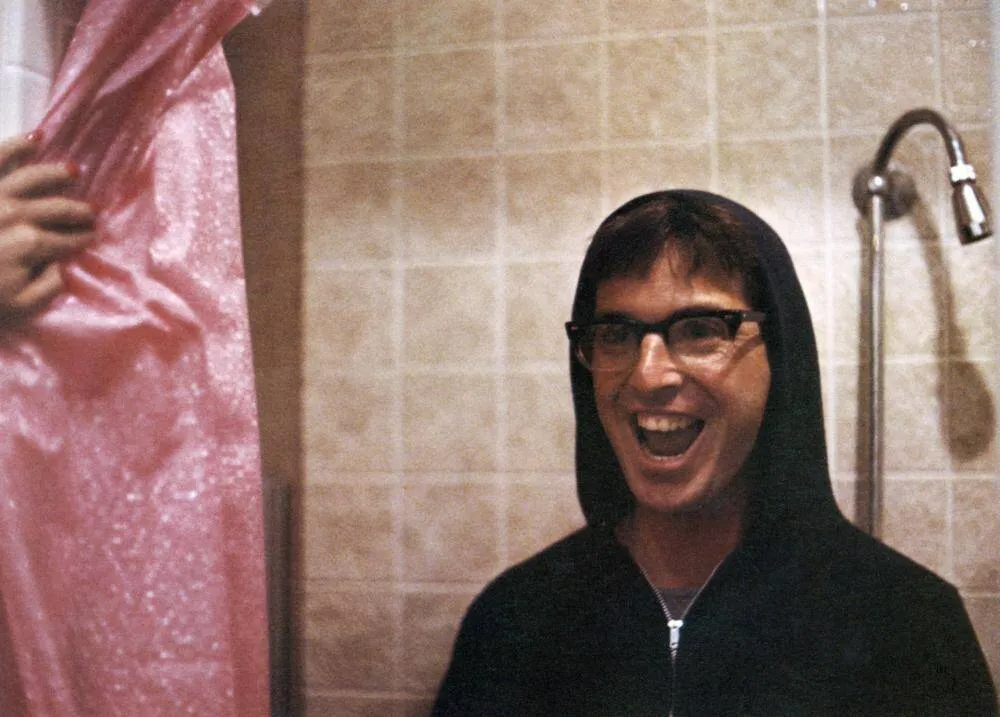 Robert Carradine grinning in shower as Lewis in Revenge of the Nerds