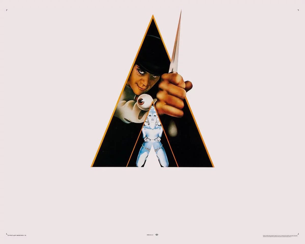 man in bowler holding knife with eyeball cufflink in [redacted]