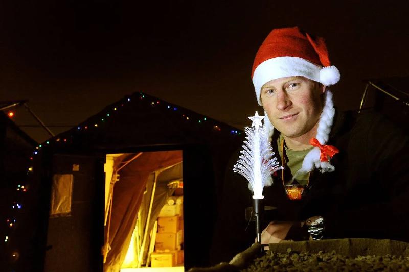 CAMP BASTION, AFGHANISTAN - DECEMBER 12:  In this previously unissued  image released on January 27, 2013, Prince Harry poses with a Christmas 
hat as he stands outside the VHR (very high readiness) tent at Camp 
Bastion on December 12, 2012 in Afghanistan. Prince Harry has served as 
an Apache Helicopter Pilot/Gunner with 662 Sqd Army Air Corps, from 
September 2012 for four months until January 2013.